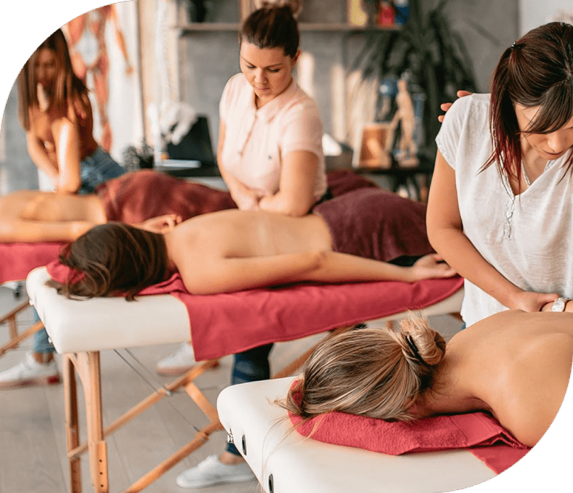 Massage therapists working on clients' backs