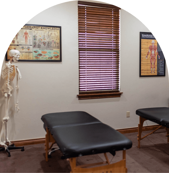 Massage clinic interior with anatomical charts