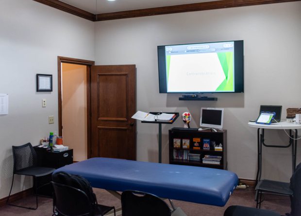 Clinic room with blue examination table